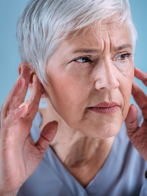 Woman cupping her hands to her ears